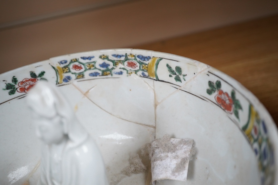 A Chinese famille verte bowl, Kangxi period and a white glazed figure of Guanyin, bowl 22cm diameter. Condition - figure good, bowl poor